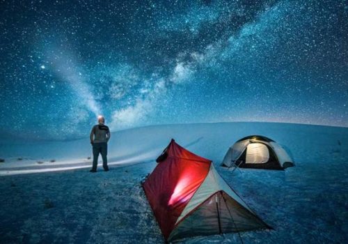 man camping under the starts at white sands